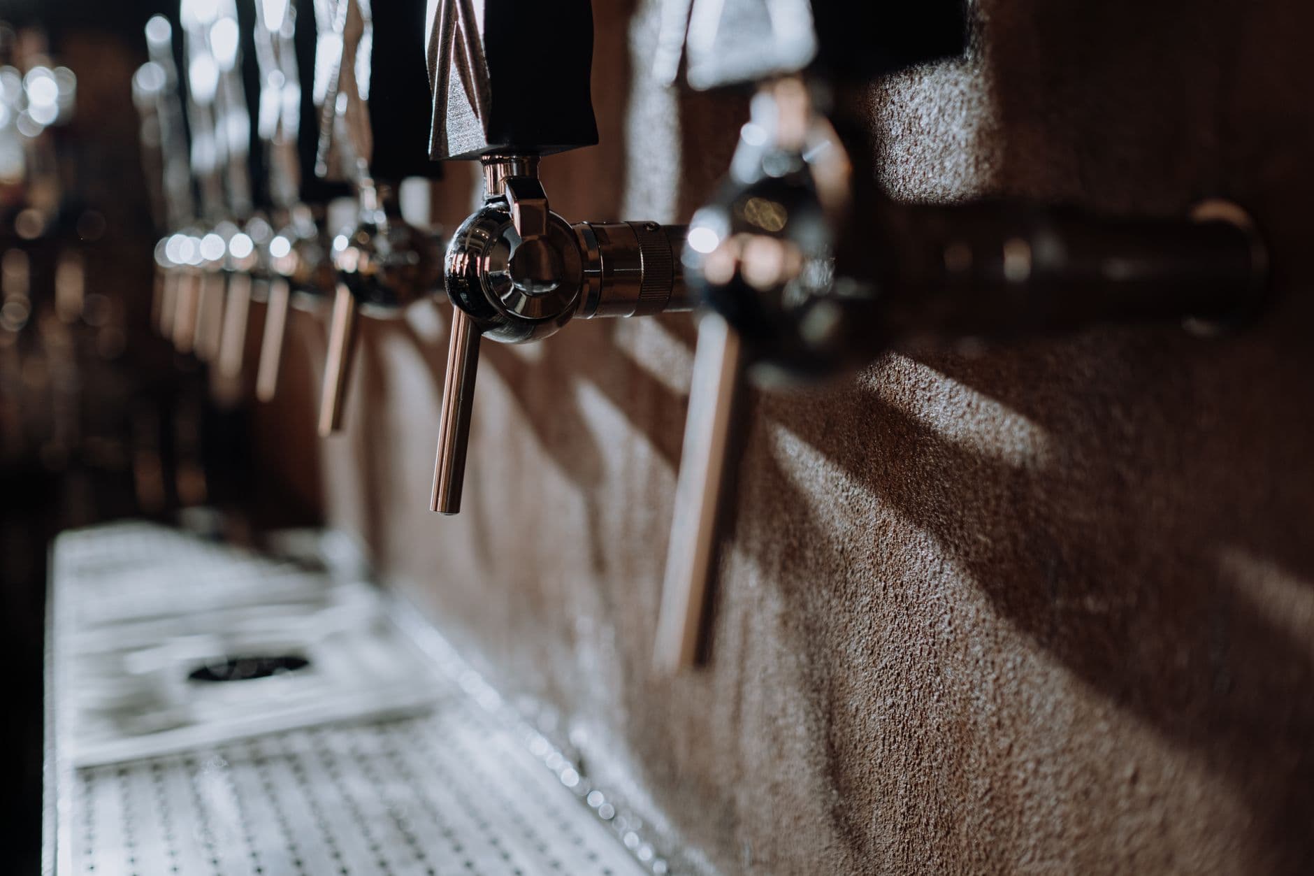 Rows of beer taps at a craft brewery